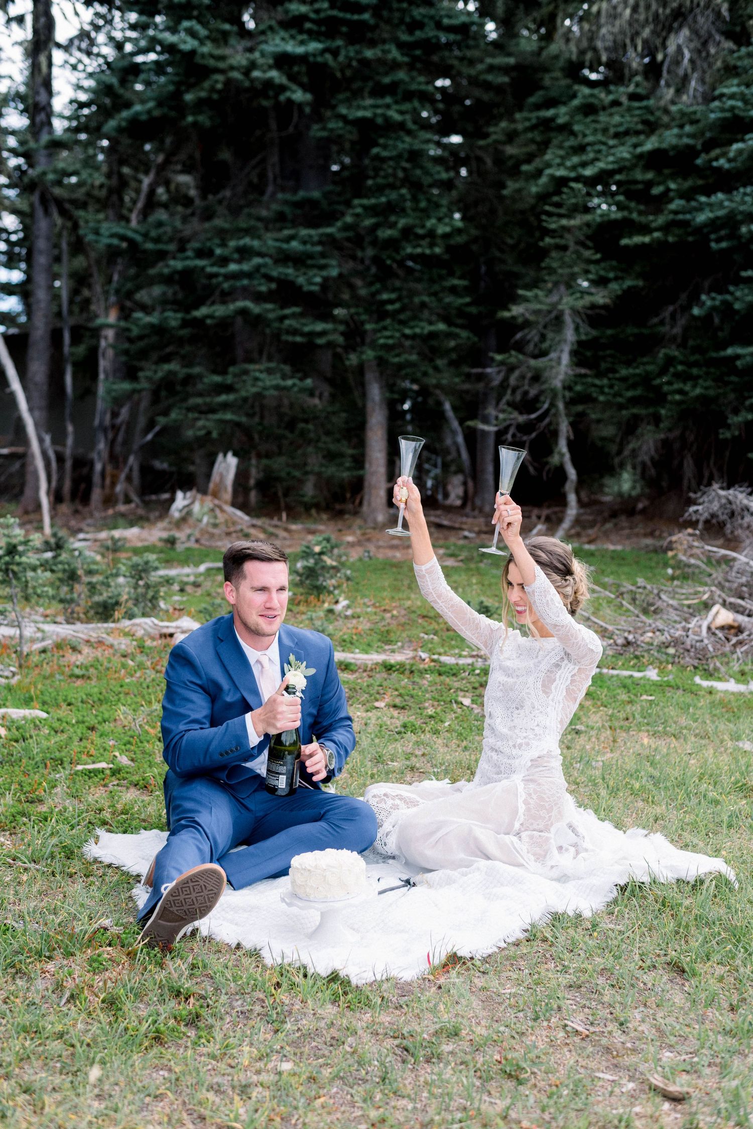Celebratory toast against backdrop of tall evergreen trees.