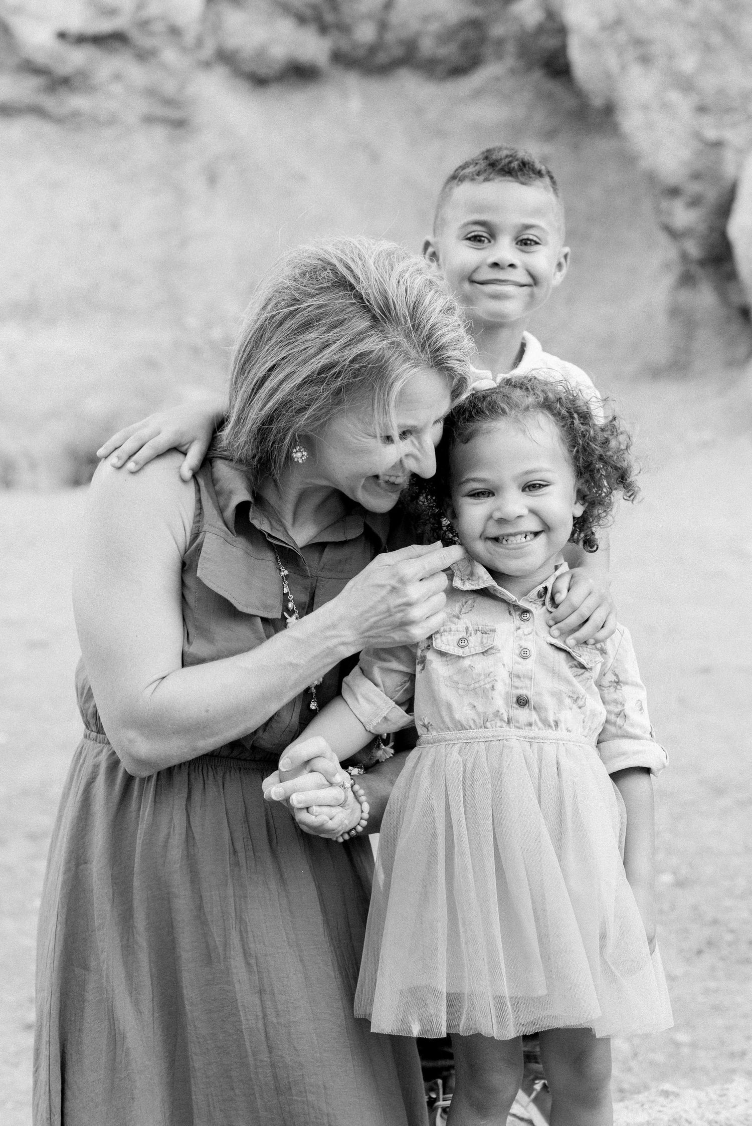 A heartwarming black and white portrait showing a tender moment between two people.