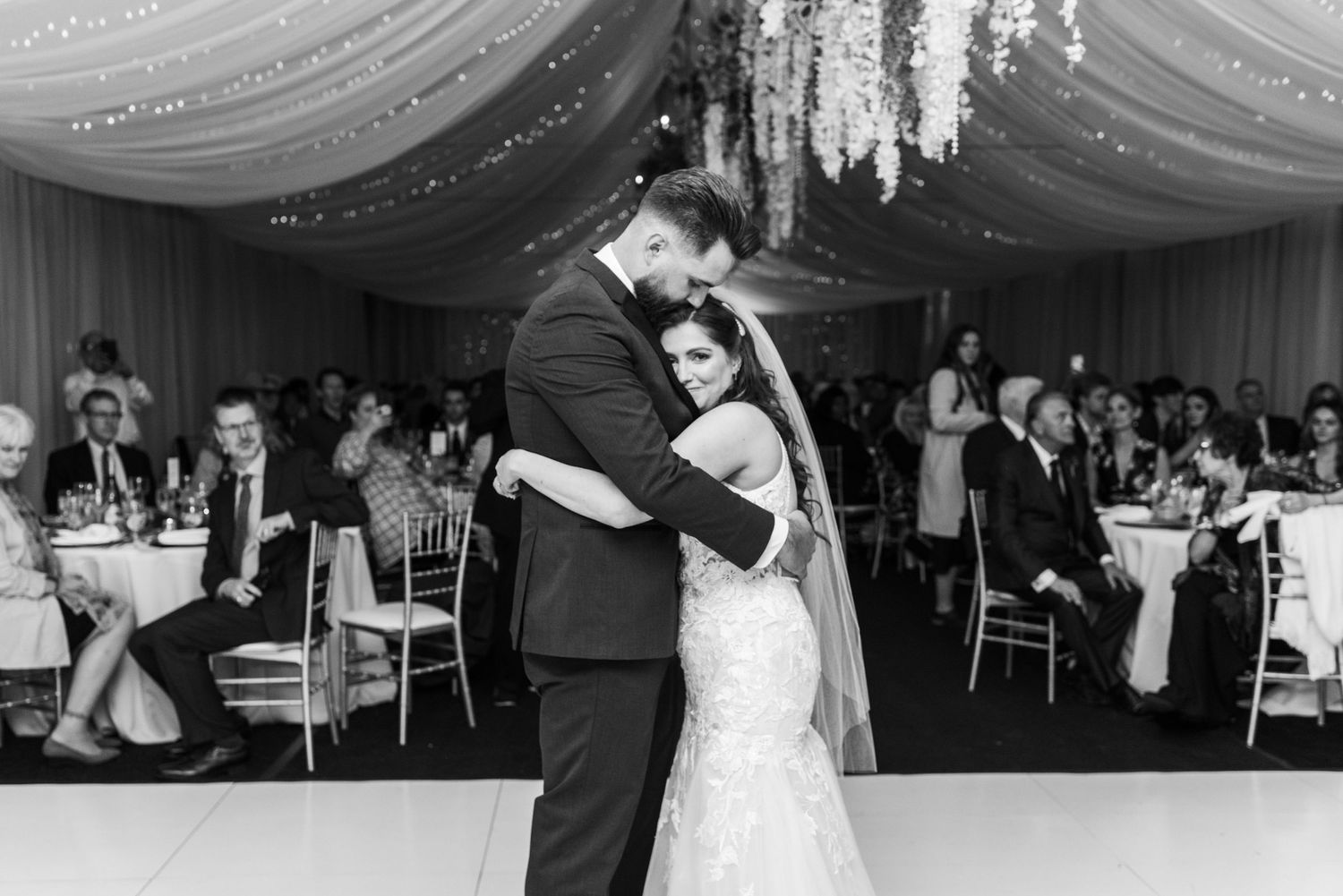 Black and white photo of couple's intimate dance moment at their wedding reception.