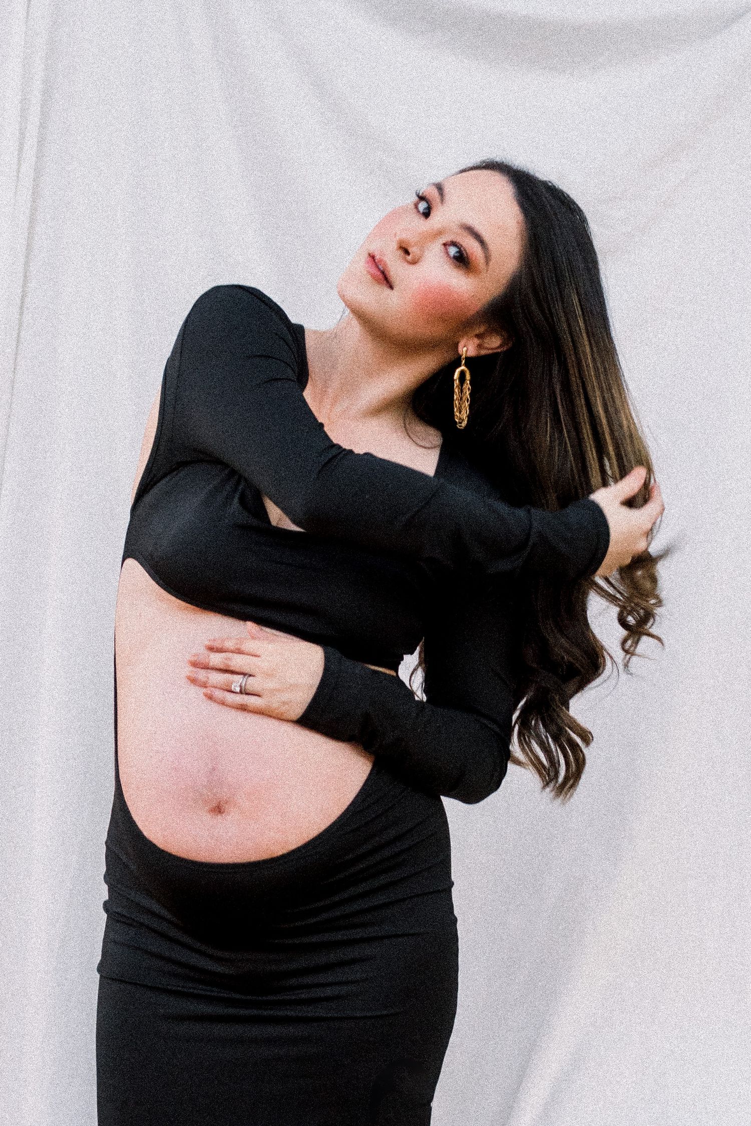 Woman in black dress poses gracefully in four artistic dance-inspired poses against white backdrop.