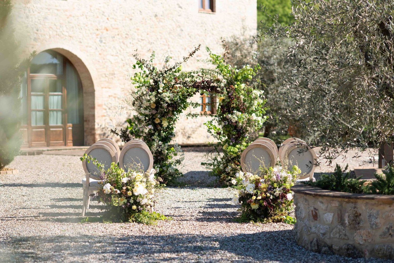 A series of connected outdoor stone walkways and garden paths with rustic architectural elements.