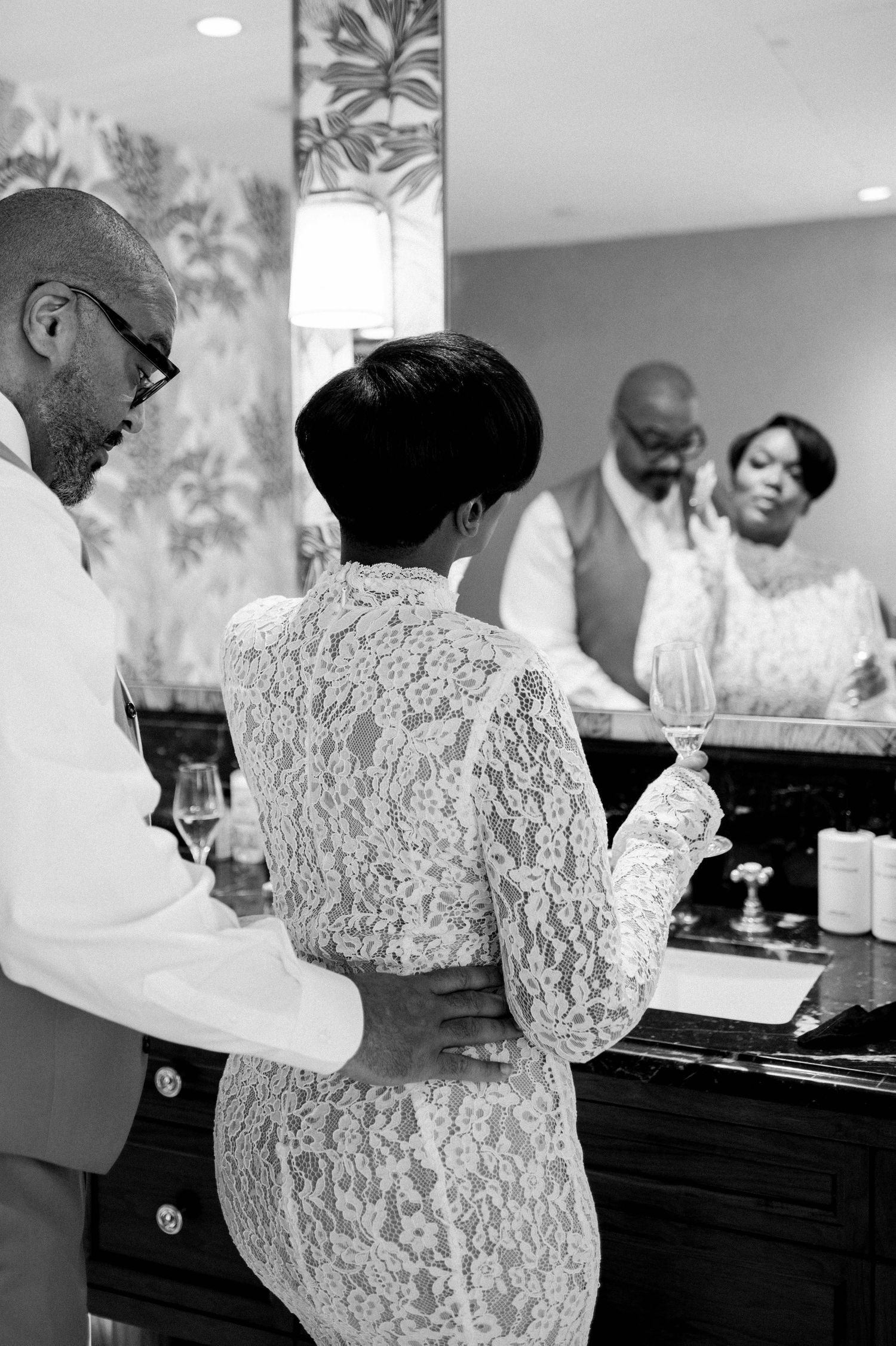A black and white photo series showing someone in a lace top preparing food at a kitchen counter.