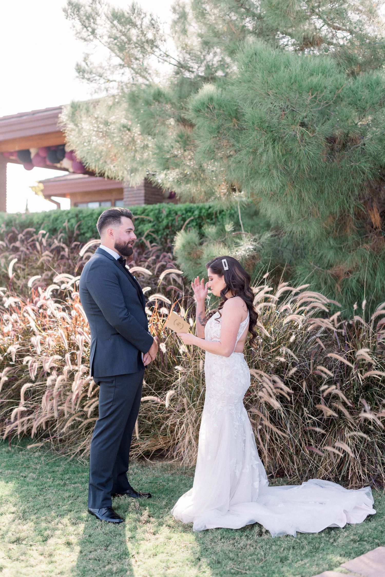 A couple shares a joyful moment during their garden wedding first look ceremony.