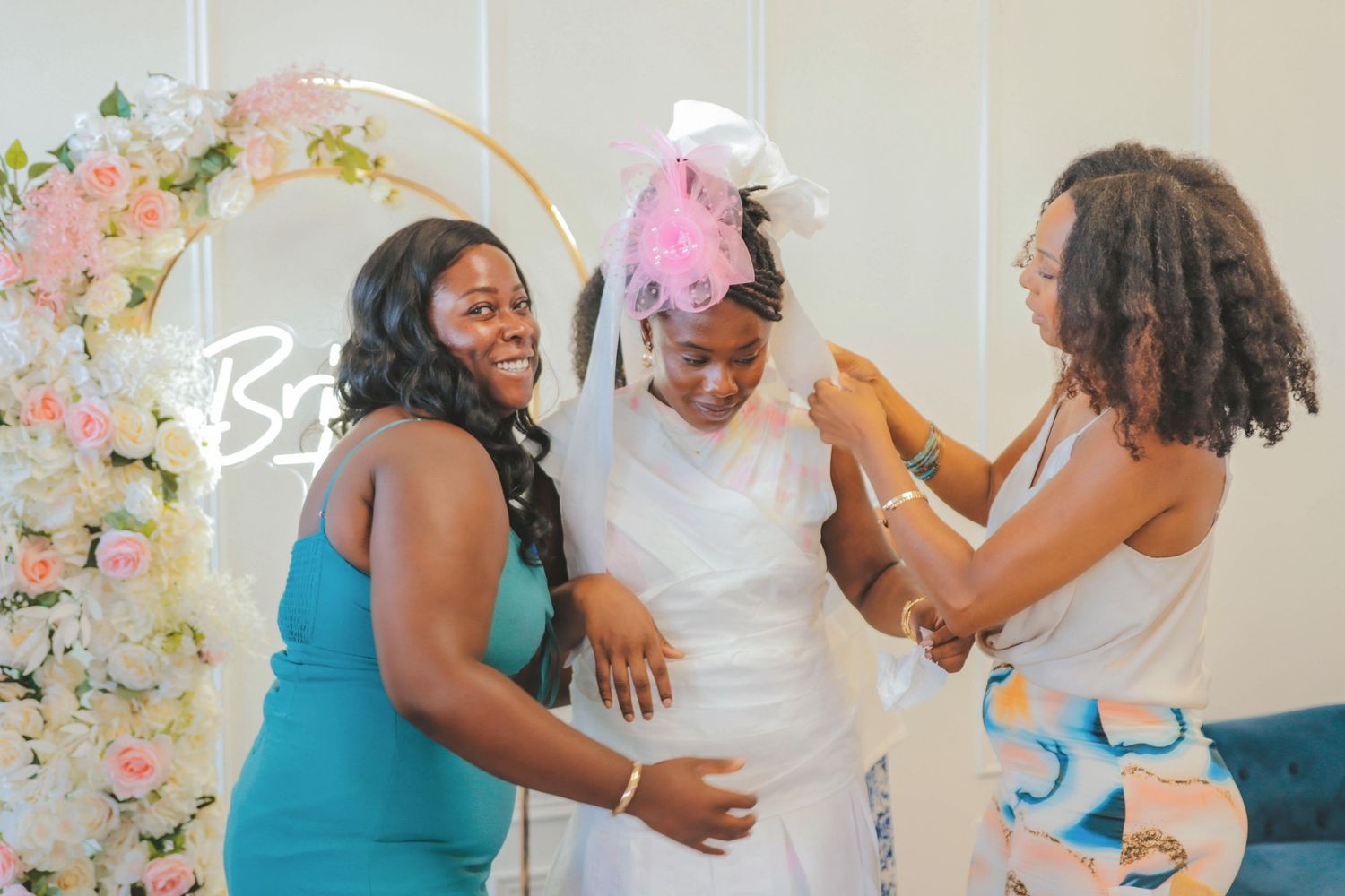 Friends helping the bride-to-be during a joyful bridal shower moment, captured in a candid and emotional style by a Calgary event photograph