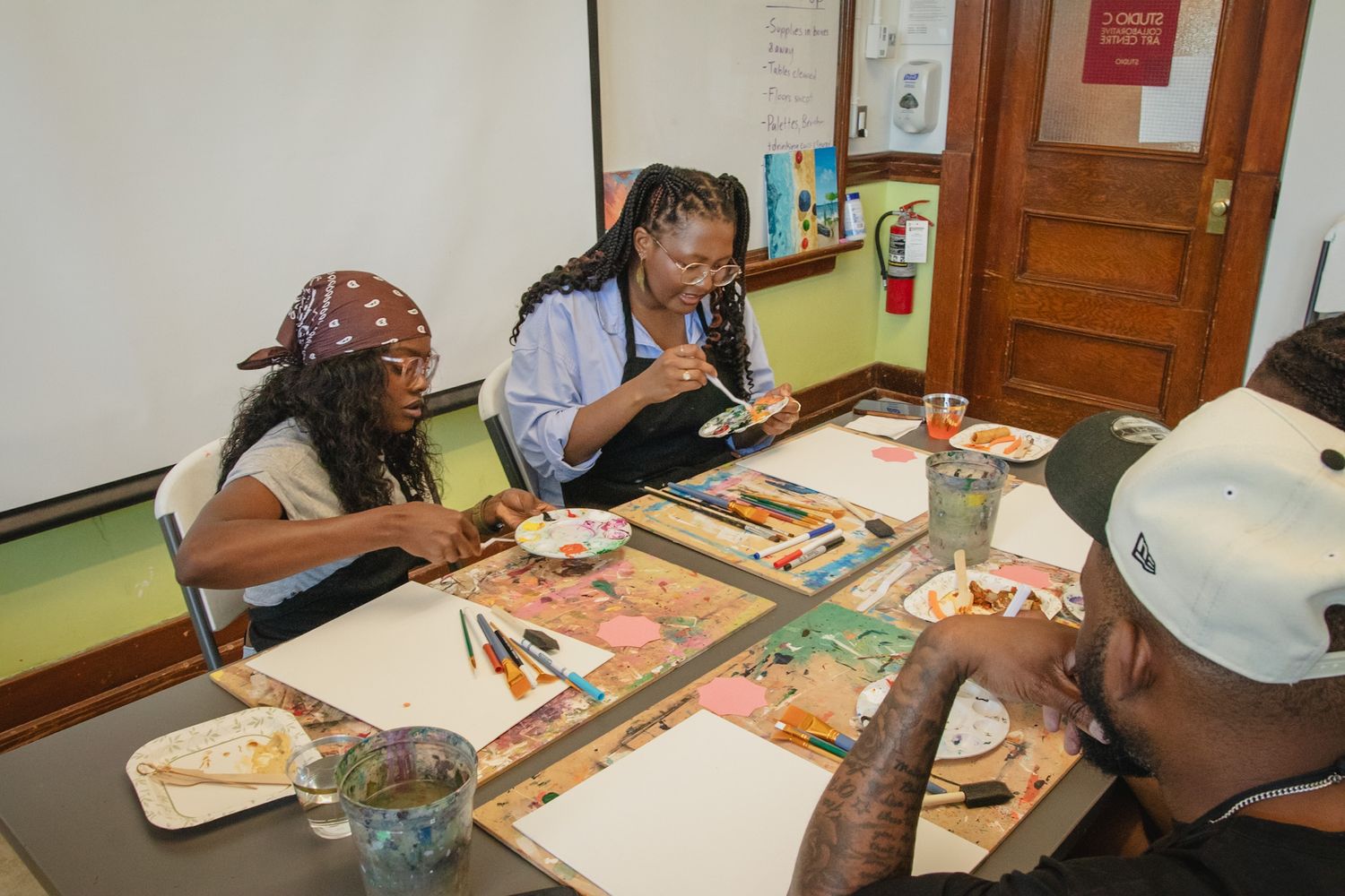 Close-up of guests painting on canvas during a creative workshop event, captured in a storytelling style by a Calgary event photographer
