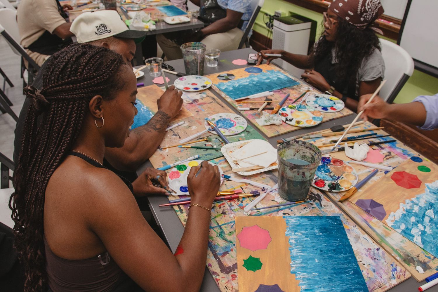 Guests painting together at a creative group event, captured in a candid and storytelling style by a Calgary event photographer