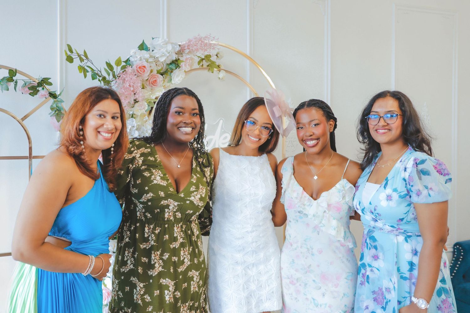 Group of women smiling and posing together at a bridal shower celebration in Calgary, captured in a clean and timeless style