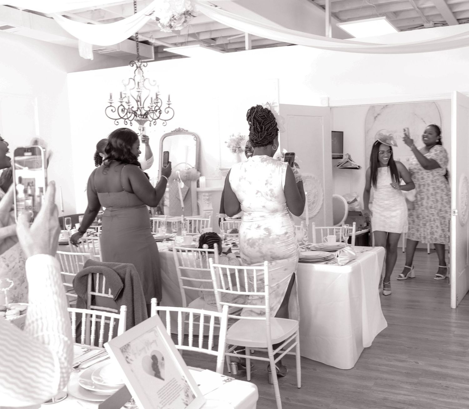Guests mingling and celebrating during an elegant bridal shower event, captured in a timeless black and white style by a Calgary event photo