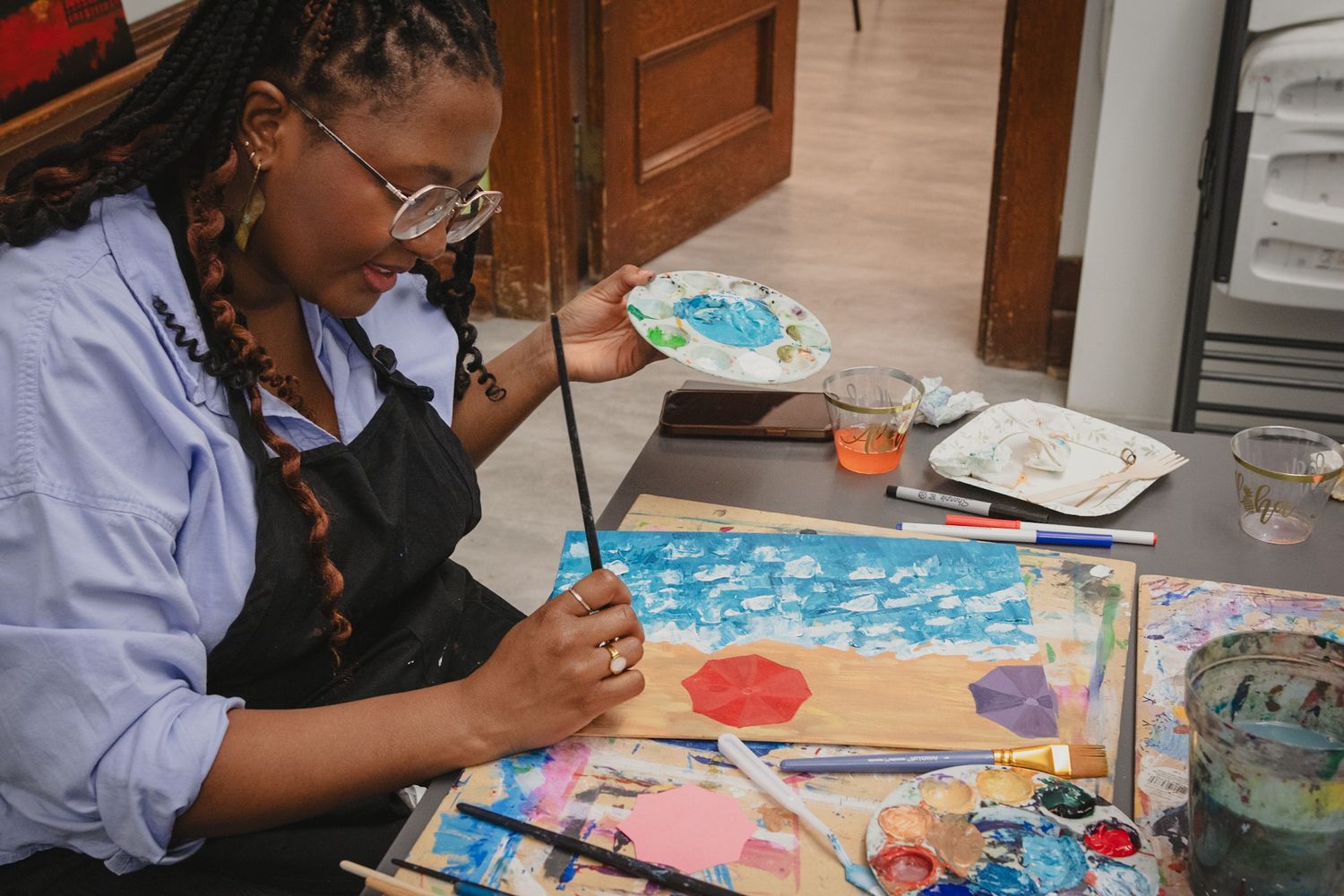 Close up shot of guests painting at a paint night event, captured by a Calgary event photographer