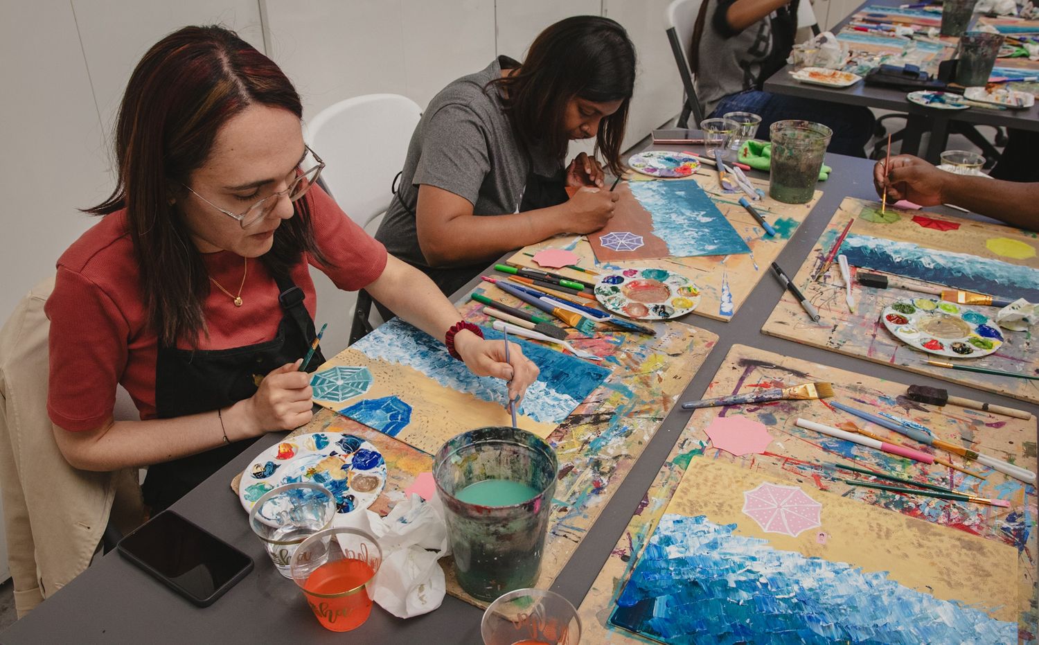 Close up shot of guests painting at a paint night event, captured by a Calgary event photographer