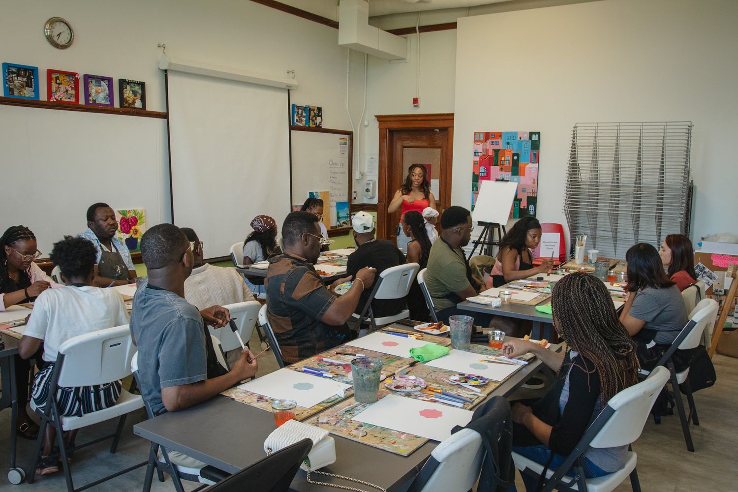 Guests participating in a guided painting workshop, captured in a candid and documentary style by a Calgary event photographer