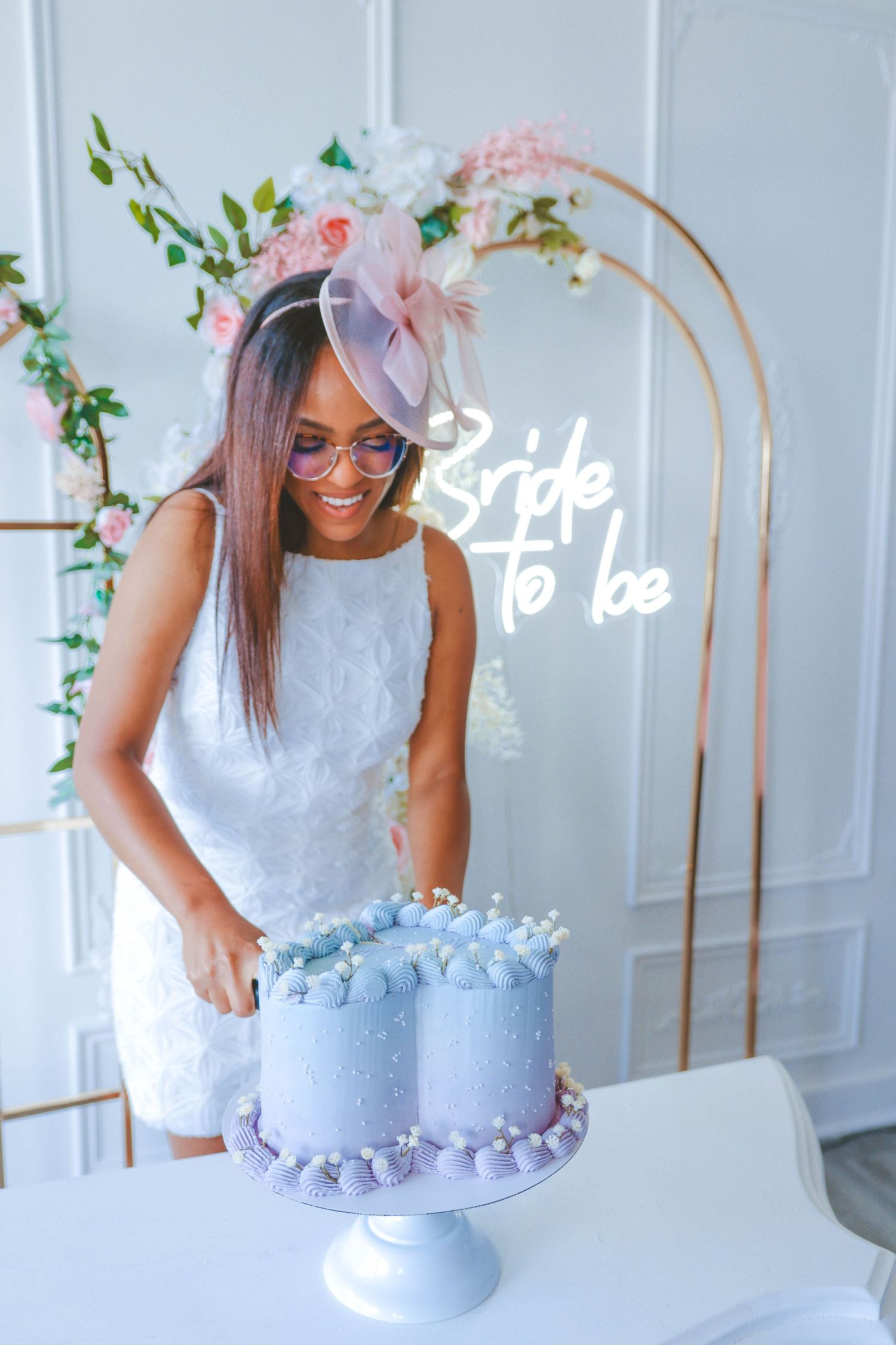 Woman cutting a cake at a bridal shower celebration, captured in a clean and timeless style by a Calgary event photographer