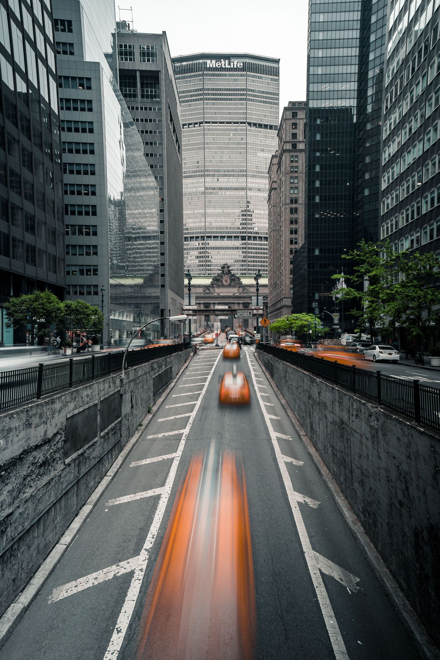 Long exposure shot of yellow taxi speeding through Midtown Manhattan tunnel toward Grand Central Terminal.