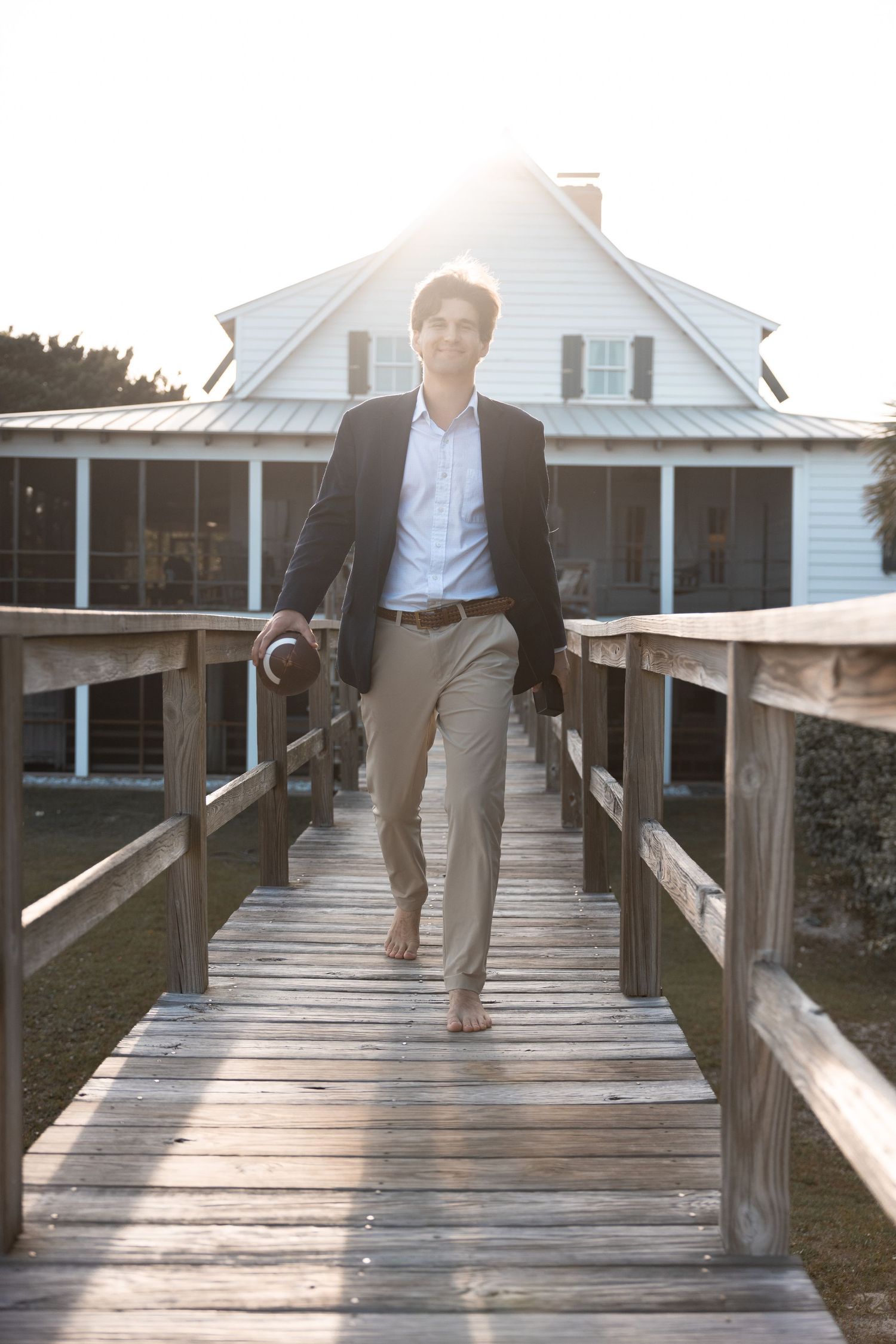 Multiple views of someone walking on a wooden boardwalk leading to a white coastal house.