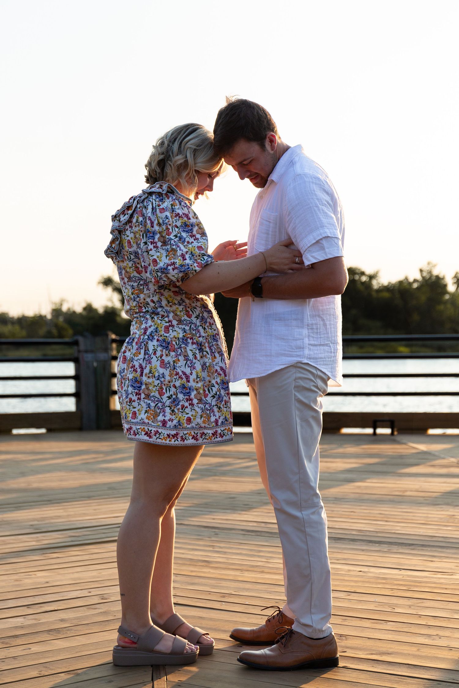 Series of photos showing a couple in floral dress and white outfit interacting on a wooden deck at sunset.