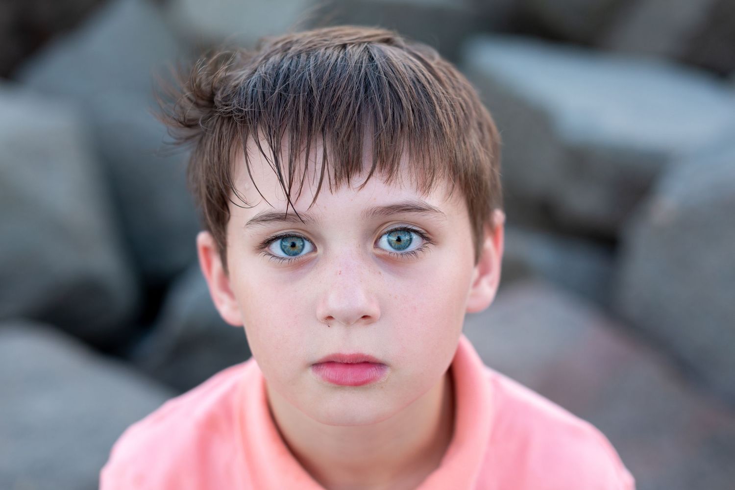 Close up portrait shot against a dark background.