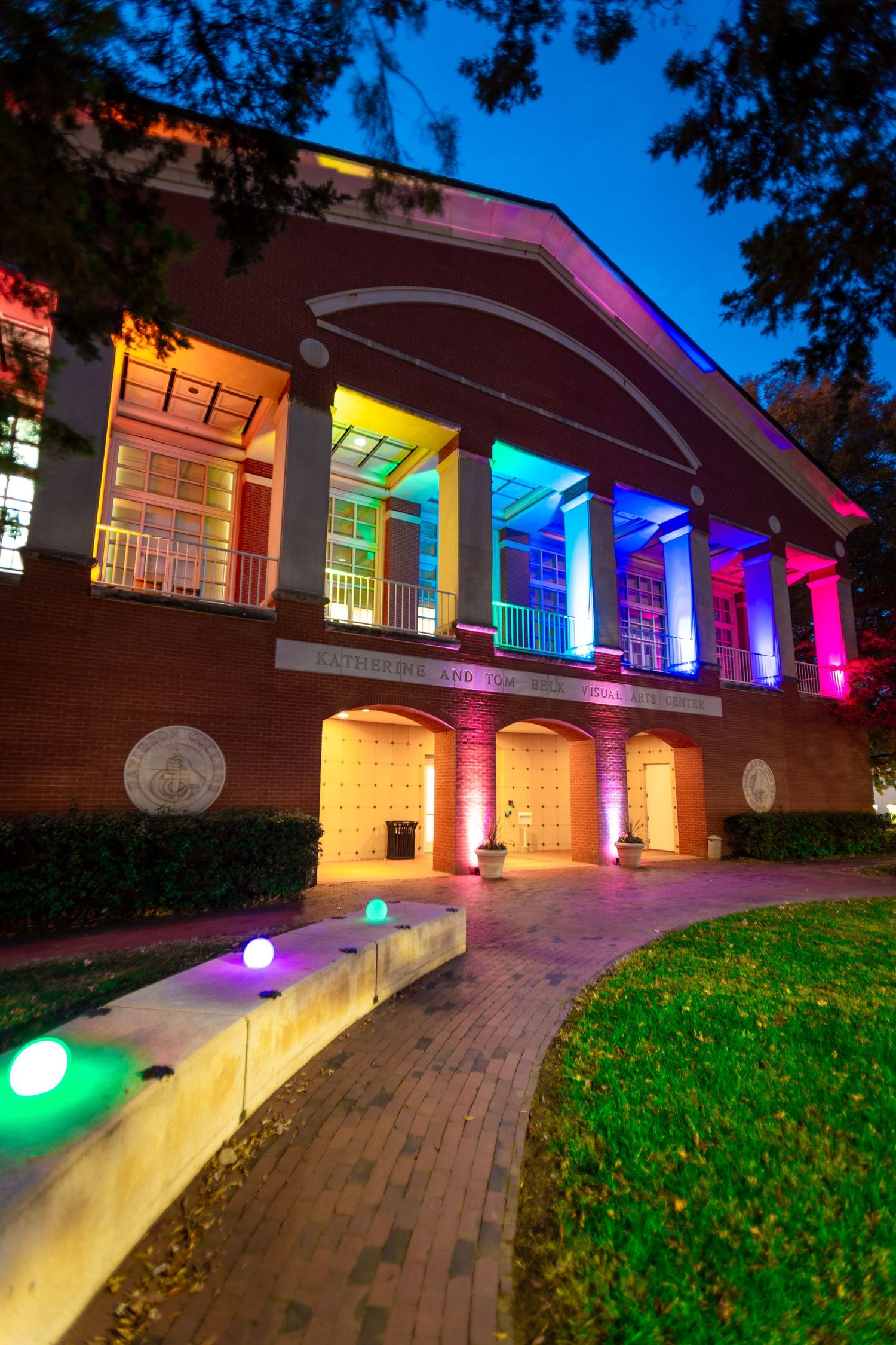 Building exterior illuminated with colorful LED lights creating a vibrant nighttime display.