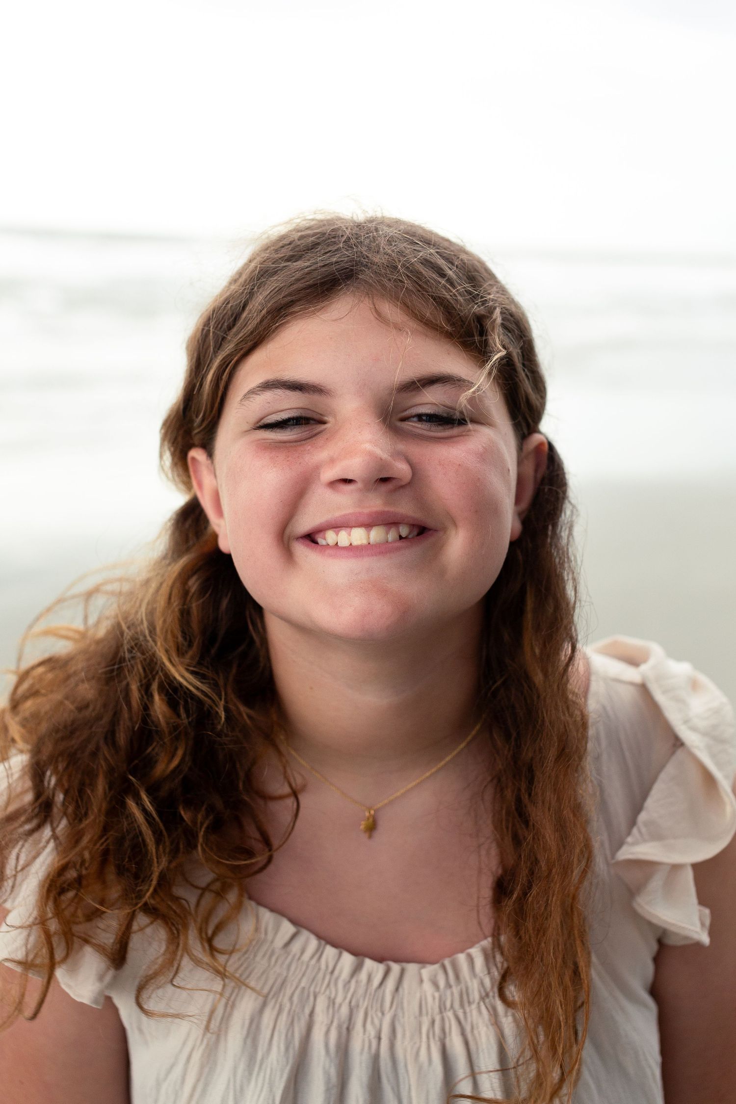 Series of close-up portraits showing someone with long brown hair and bright smile.