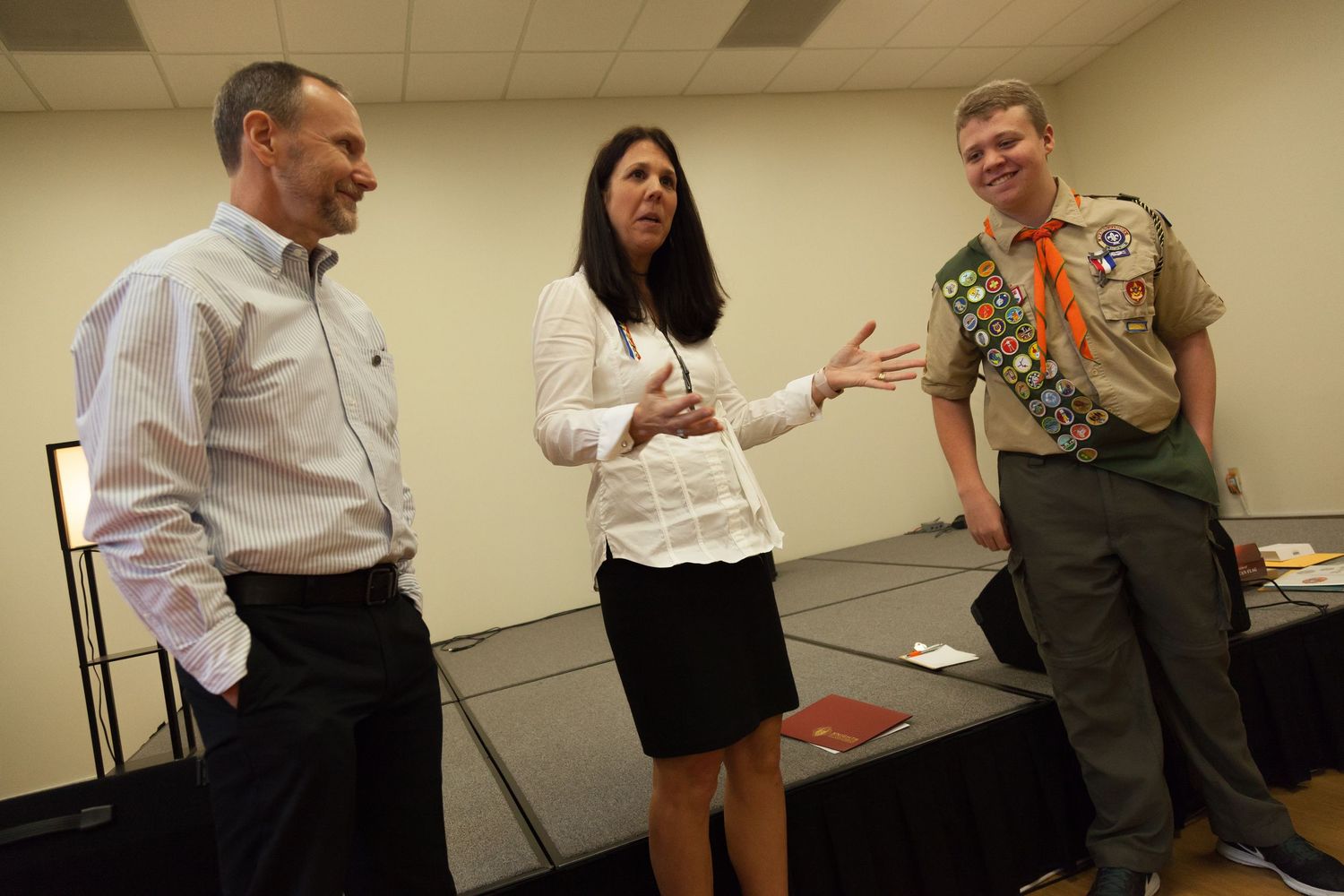 Group of business professionals engaged in an animated discussion during an office meeting.