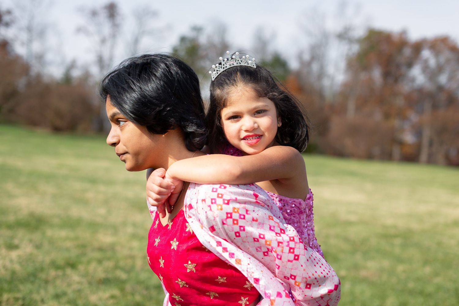 Candid family moments captured in outdoor setting with natural light.