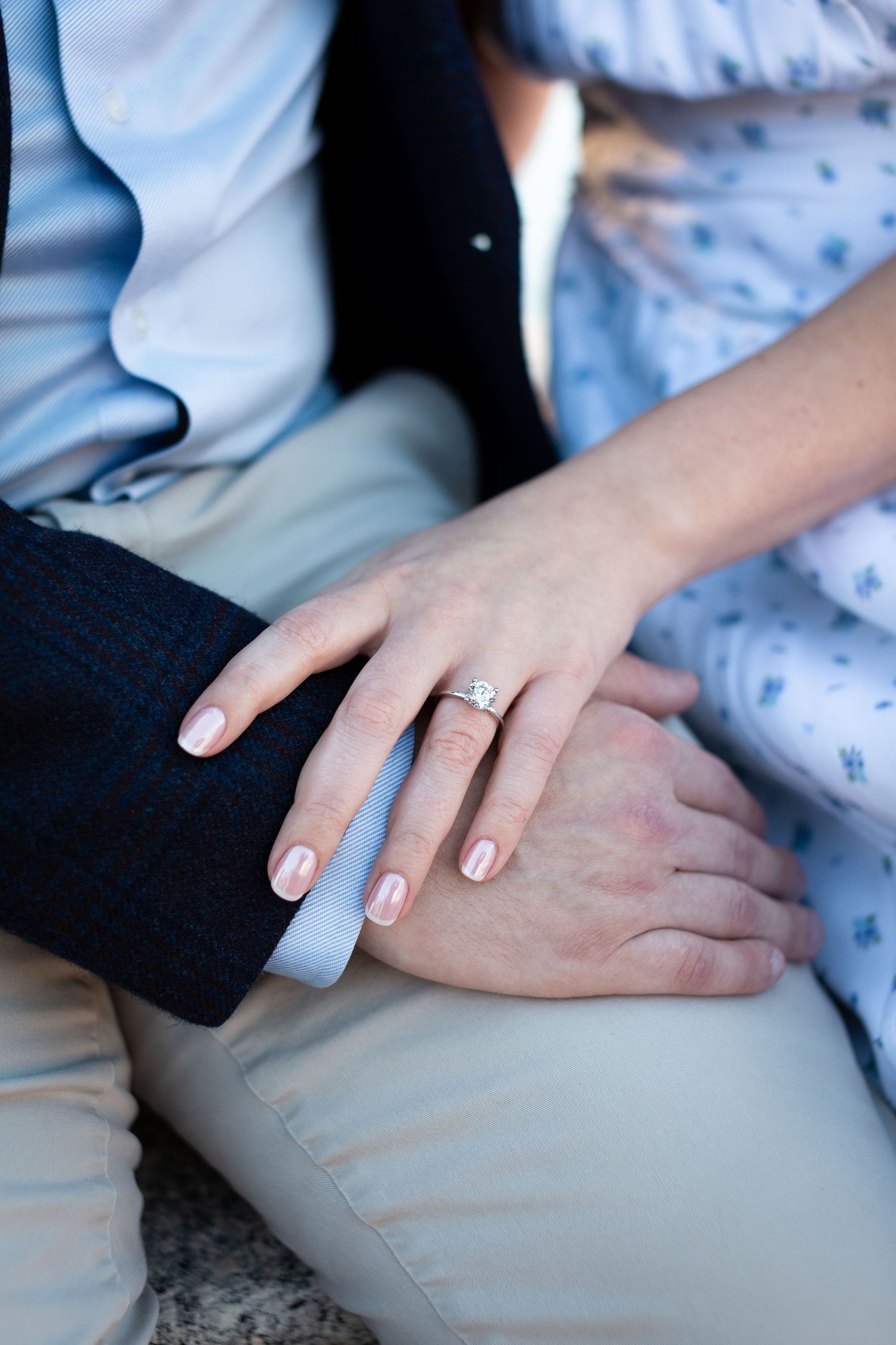 Close-up series of hands showing off a diamond engagement ring with neutral colored clothing and manicured nails.