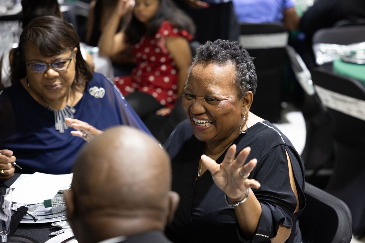 Group of attendees engaged in lively conversation during a social gathering or event.