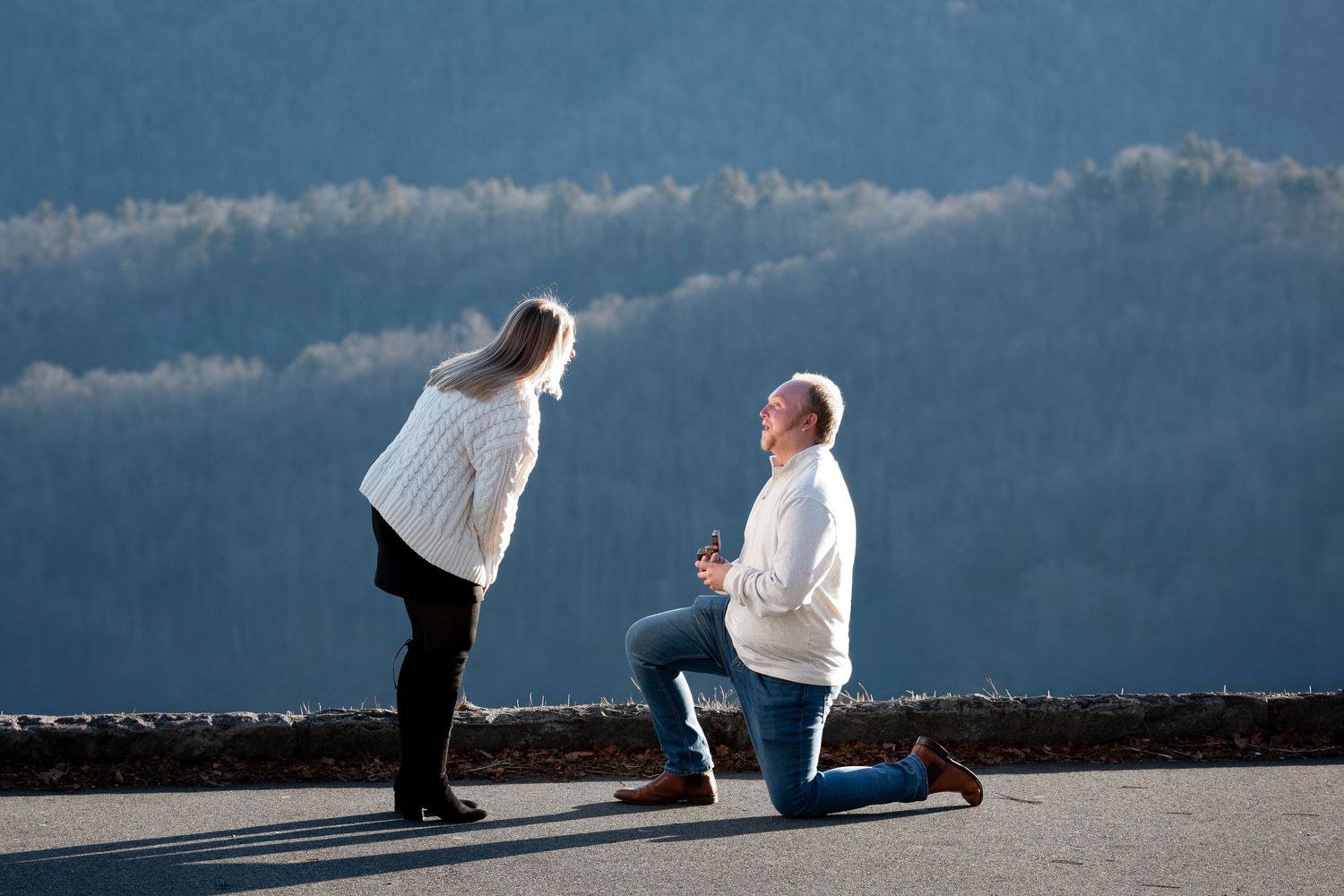 A romantic proposal silhouette sequence against a dramatic cloudy sky background at sunset.