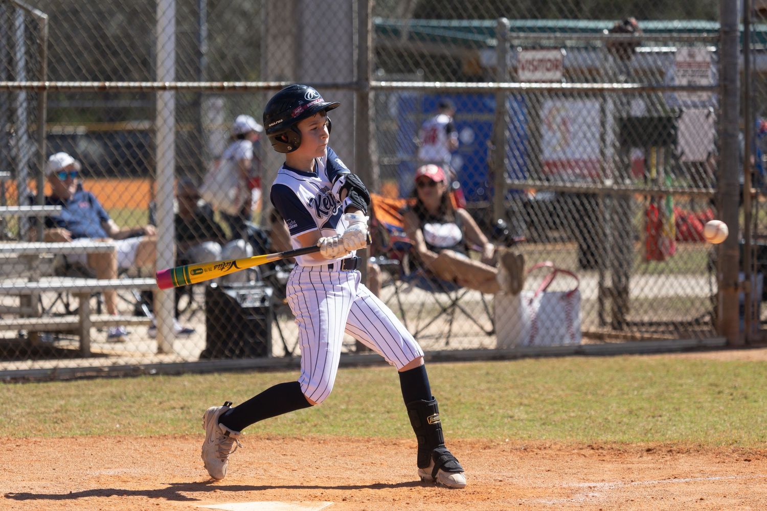 Baseball players dive and slide during close play at home plate.