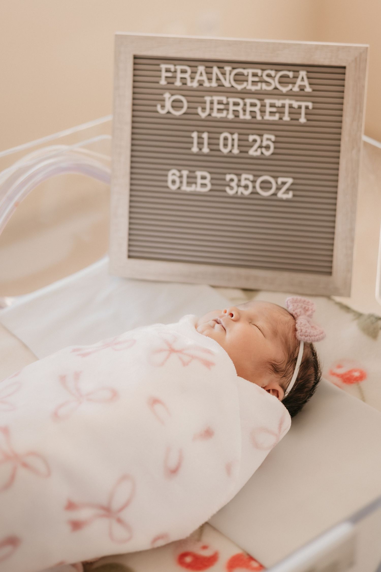 Newborn baby Francesca Jo Jerrett, born 11-01-25, weighing 6lb 3.5oz, swaddled in floral wrap.