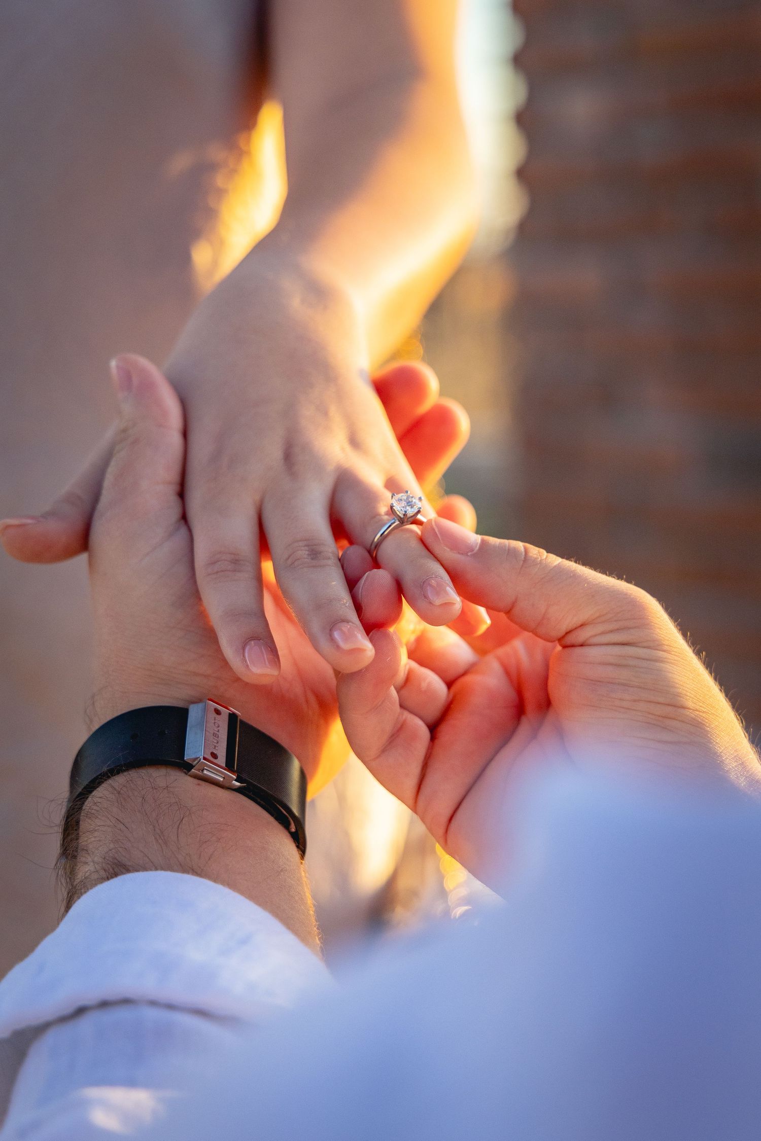 Close-up photo sequence showing hands exchanging an engagement ring during a romantic proposal moment.
