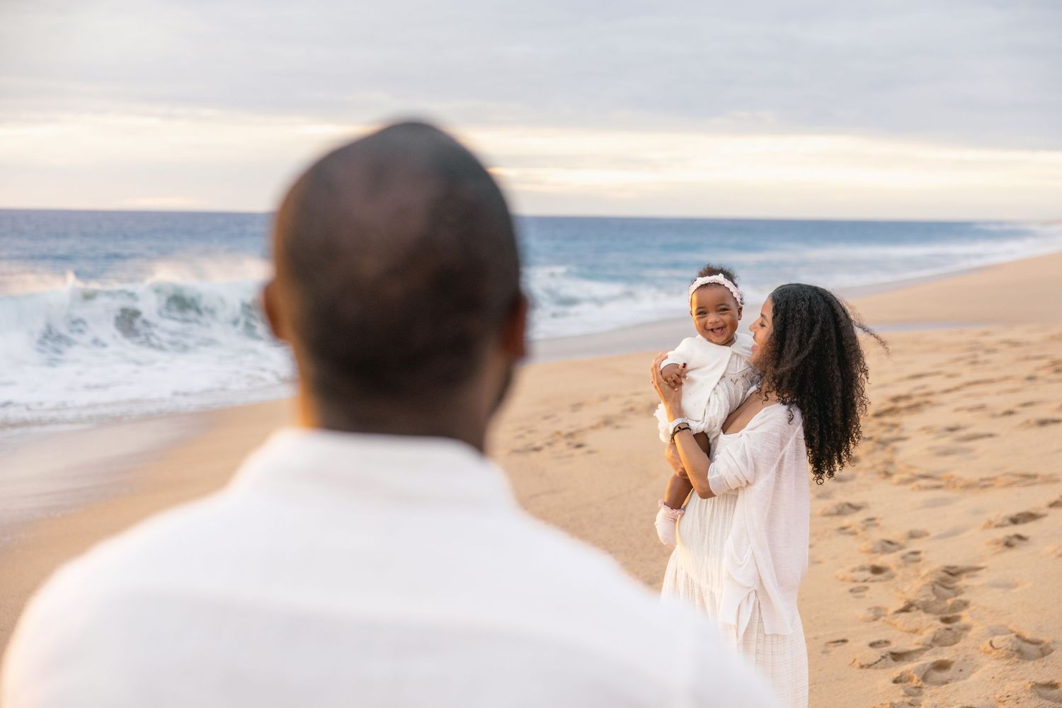 A series of candid beach photos showing people walking along the sandy shore with ocean waves in the background.
