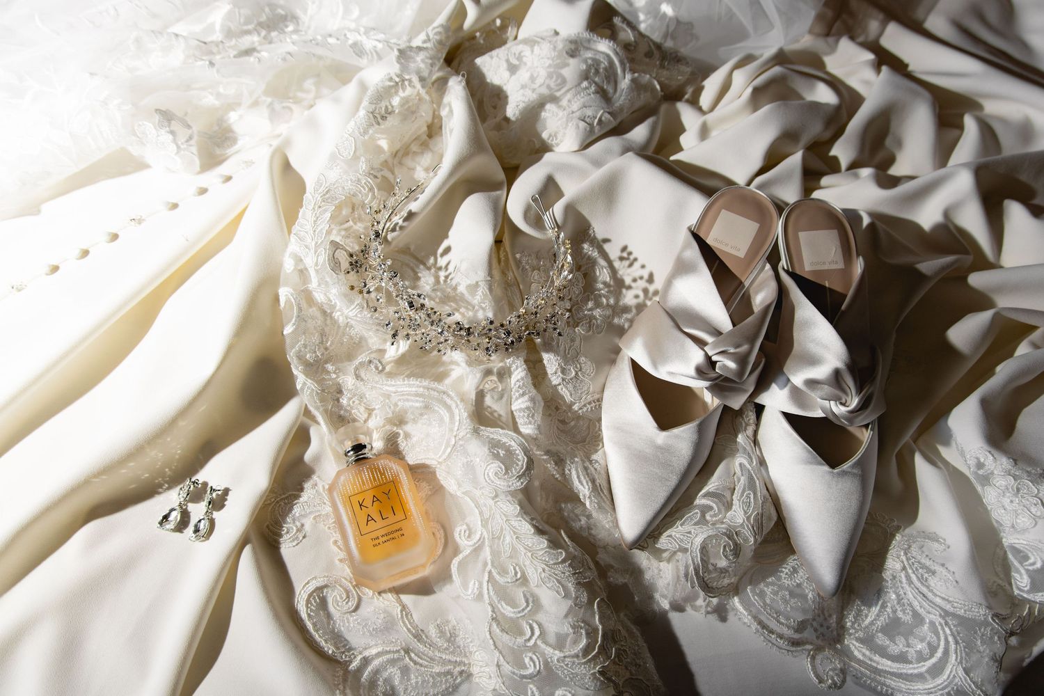 Intricate lace details and embellishments on a white wedding dress.