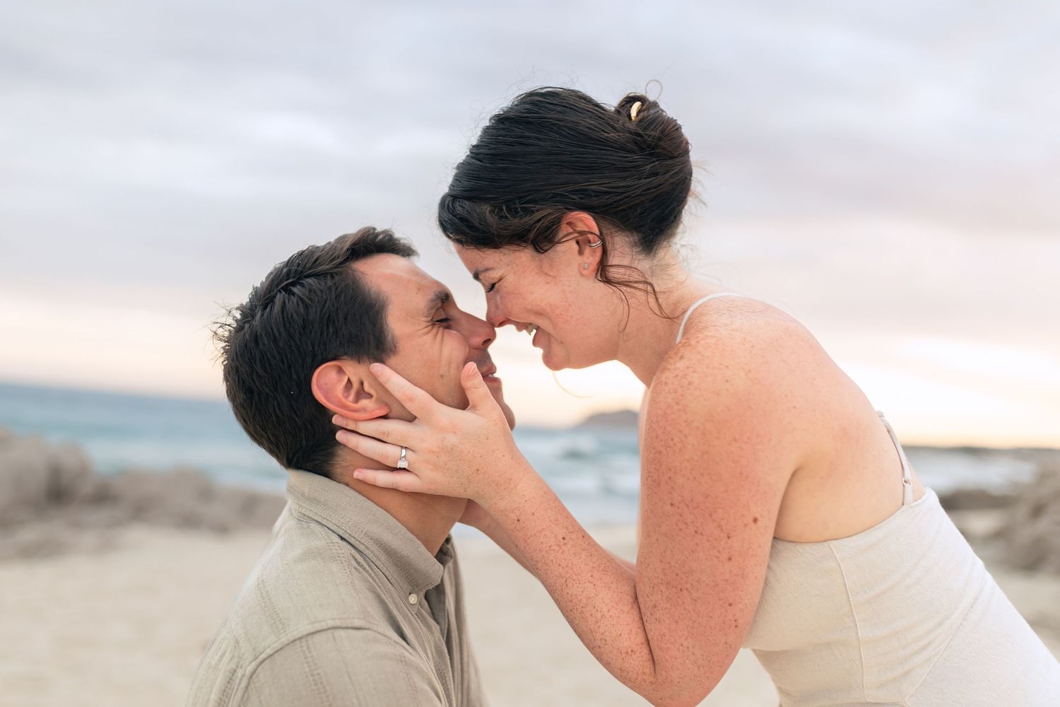 A romantic series of intimate moments between a couple at sunset on a beach.