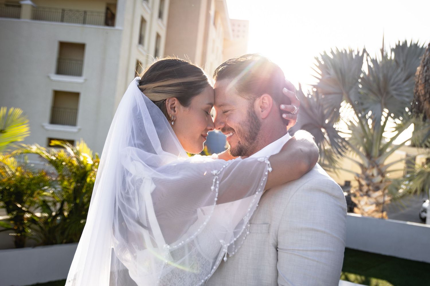 Romantic sunset wedding photos with golden light streaming through.
