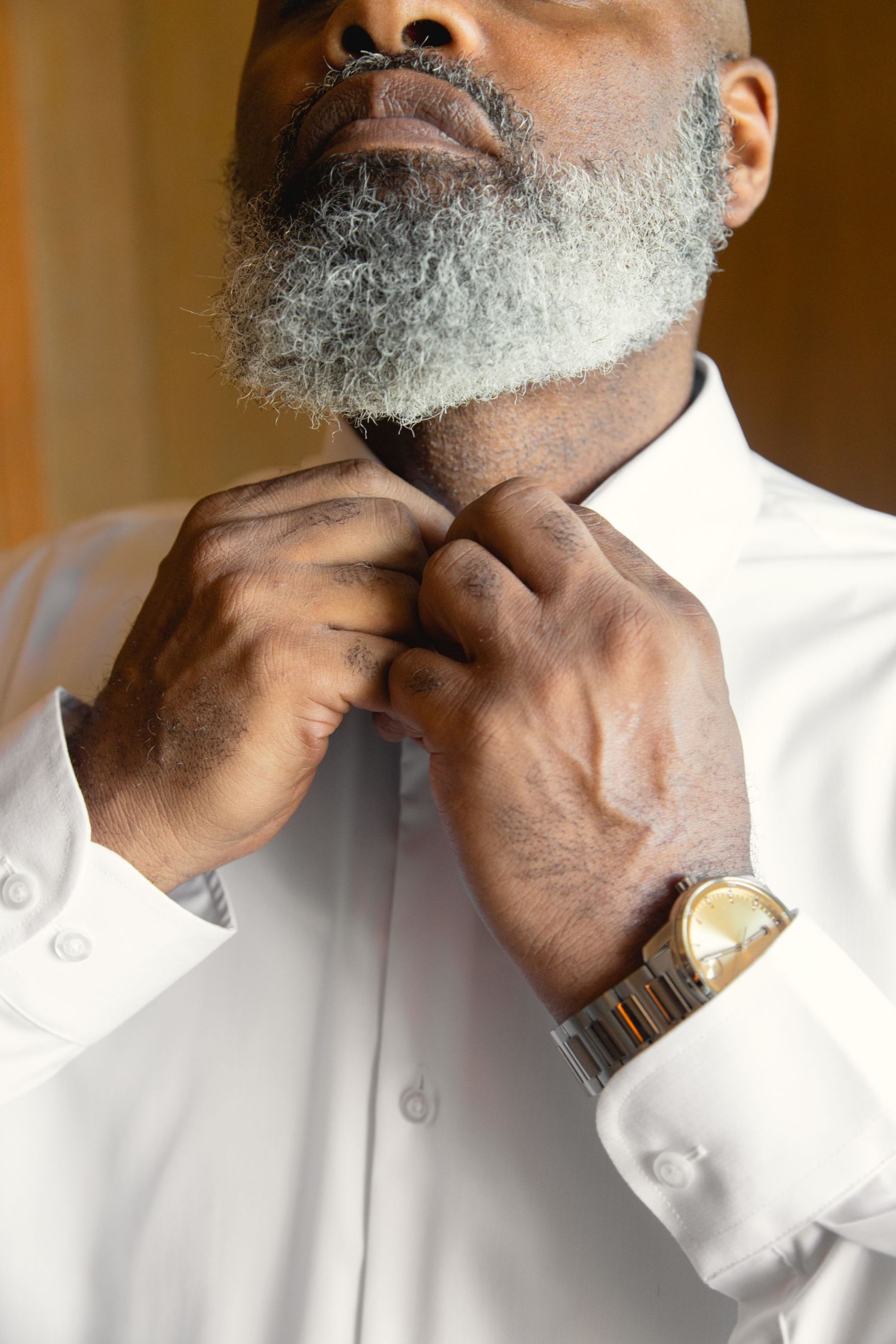 Person in white dress shirt adjusting collar and tie in a series of photos.
