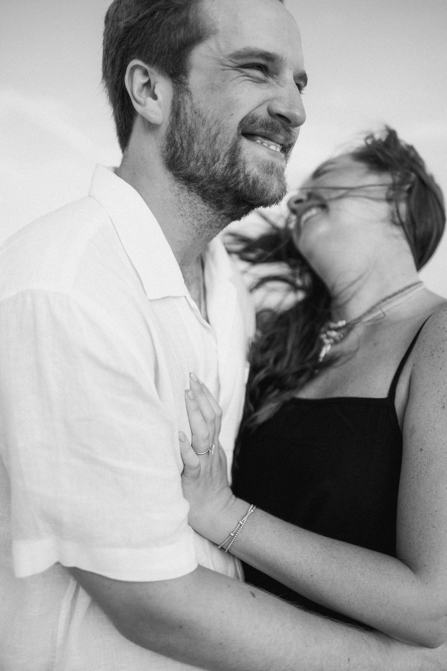 A romantic black and white photo series showing a couple in an intimate embrace and kiss sequence.