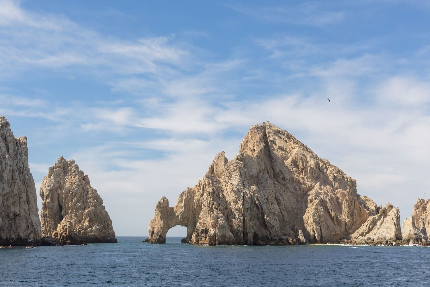 Panoramic view of the iconic Land's End rock formations and arches rising from the Pacific Ocean in Cabo San Lucas, Mexico.
