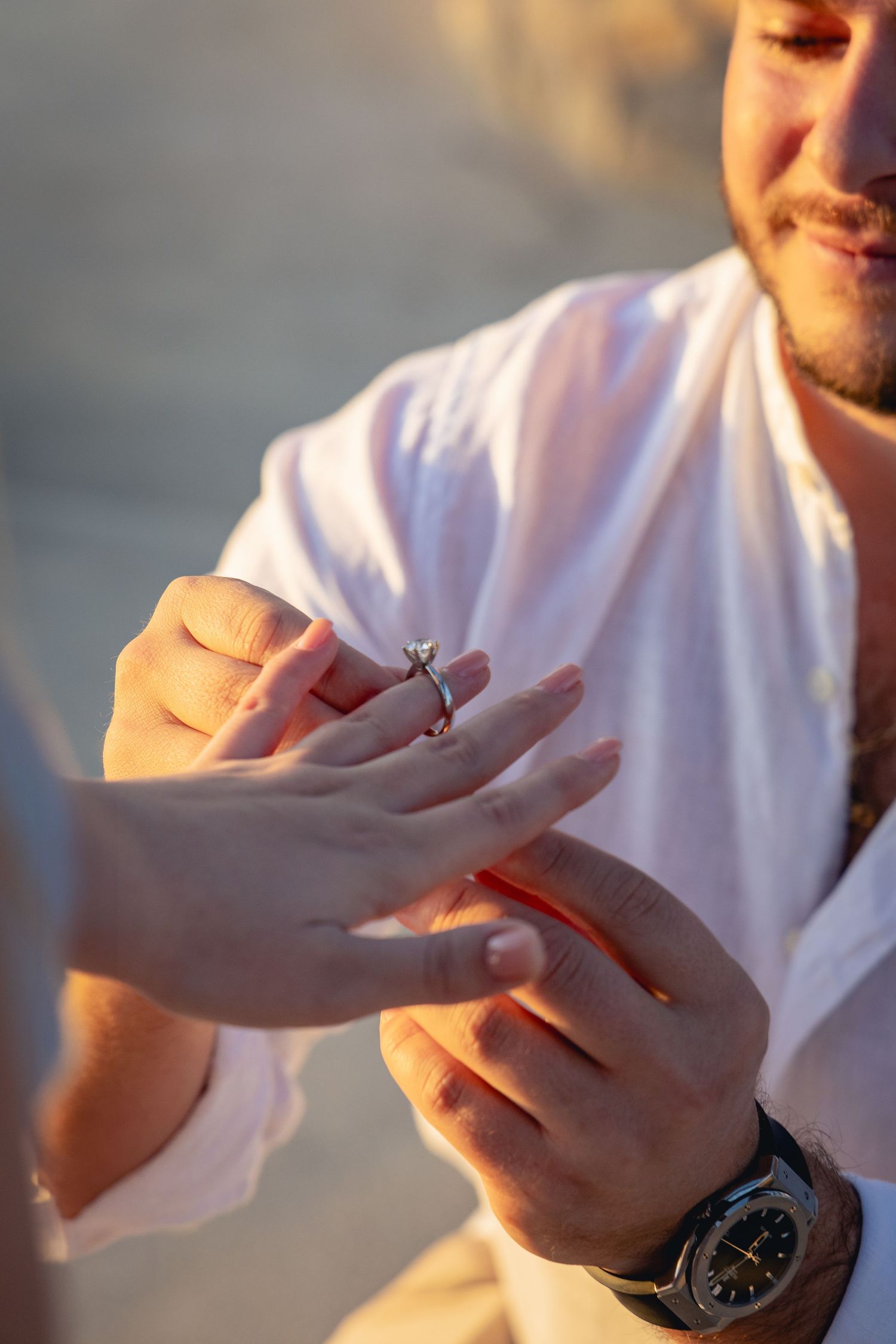 A close-up sequence of hands rolling a cigarette in warm sunset lighting.