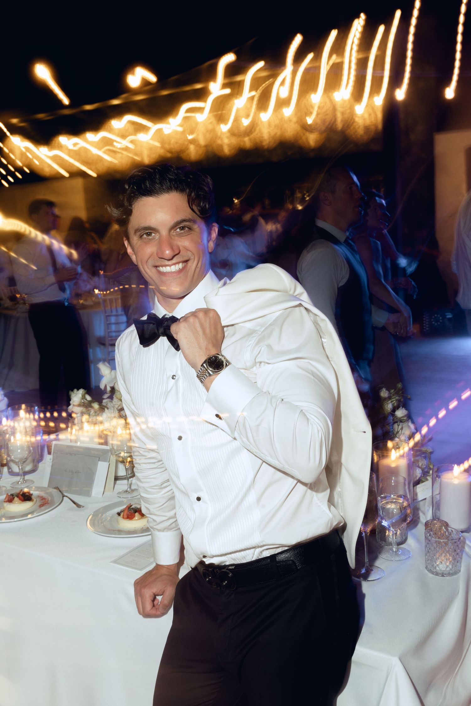 A playful cake smashing sequence at a wedding reception with the couple in formal attire.