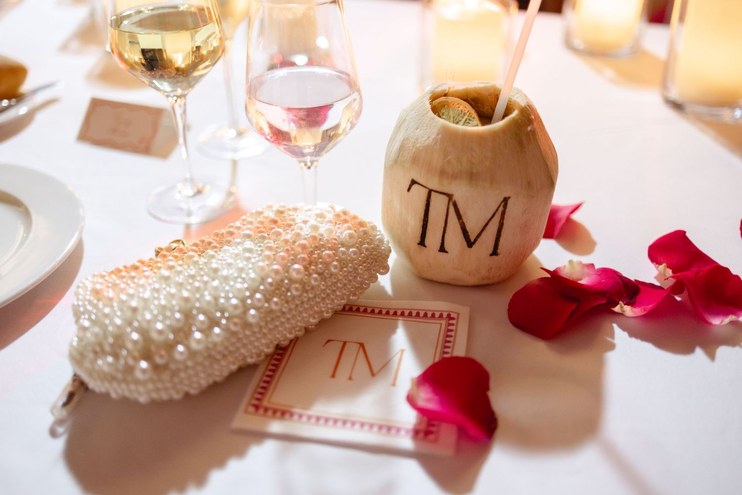 Wedding reception table details with champagne glasses and decorative elements.