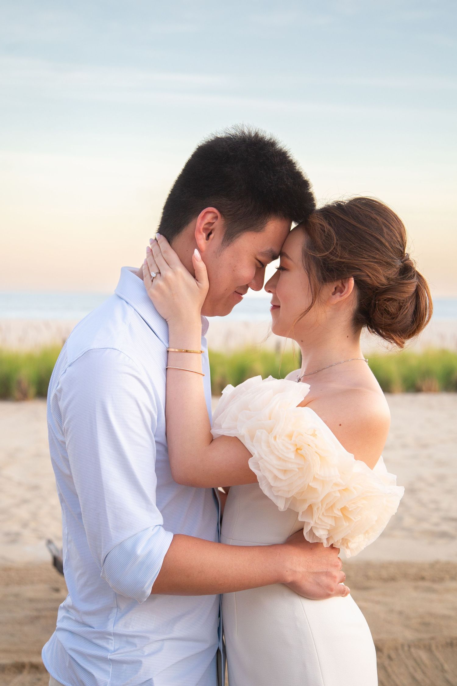 A romantic couple embraces on the beach at sunset in a series of intimate wedding photos.