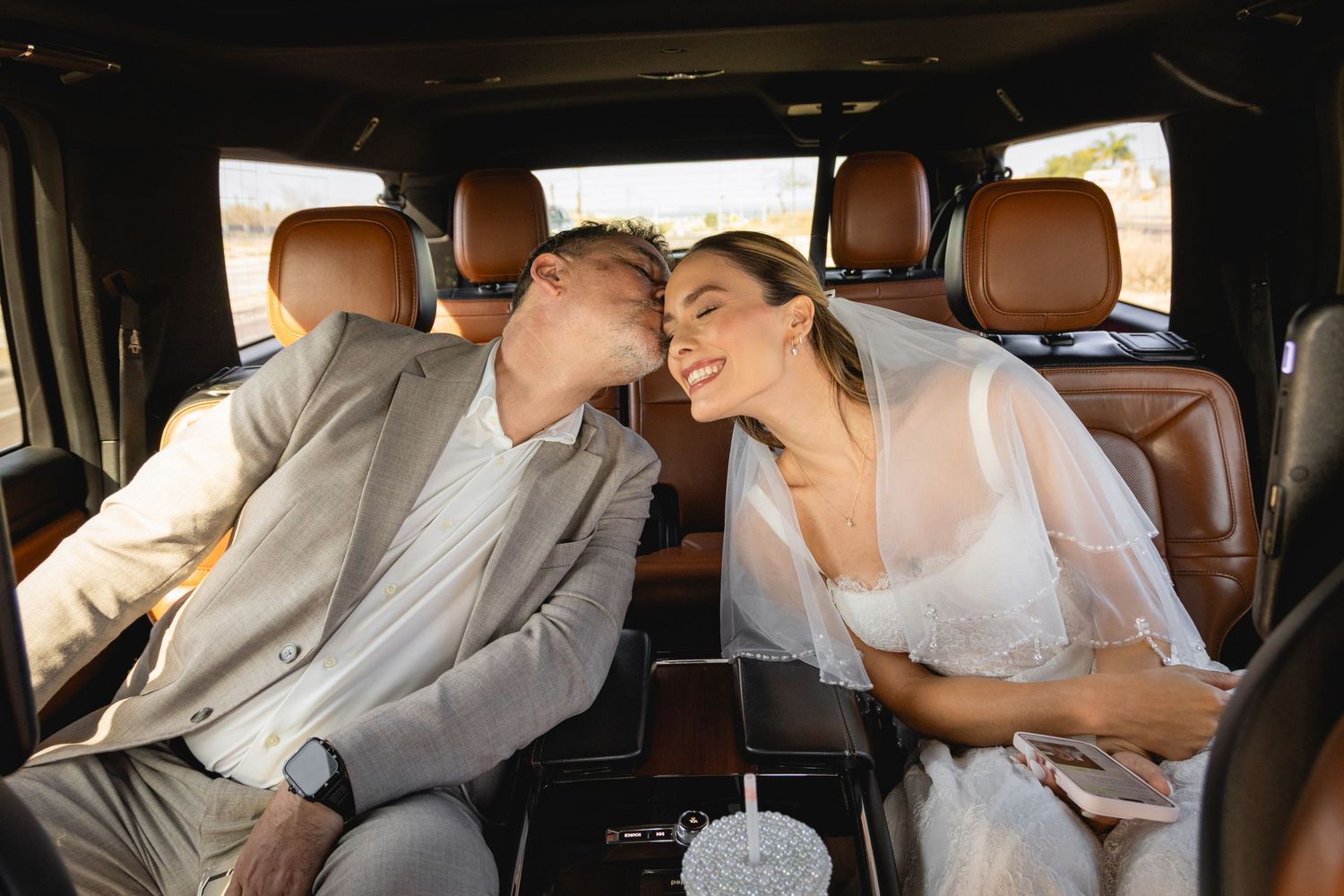Interior of luxury vehicle with leather seats during wedding celebration.