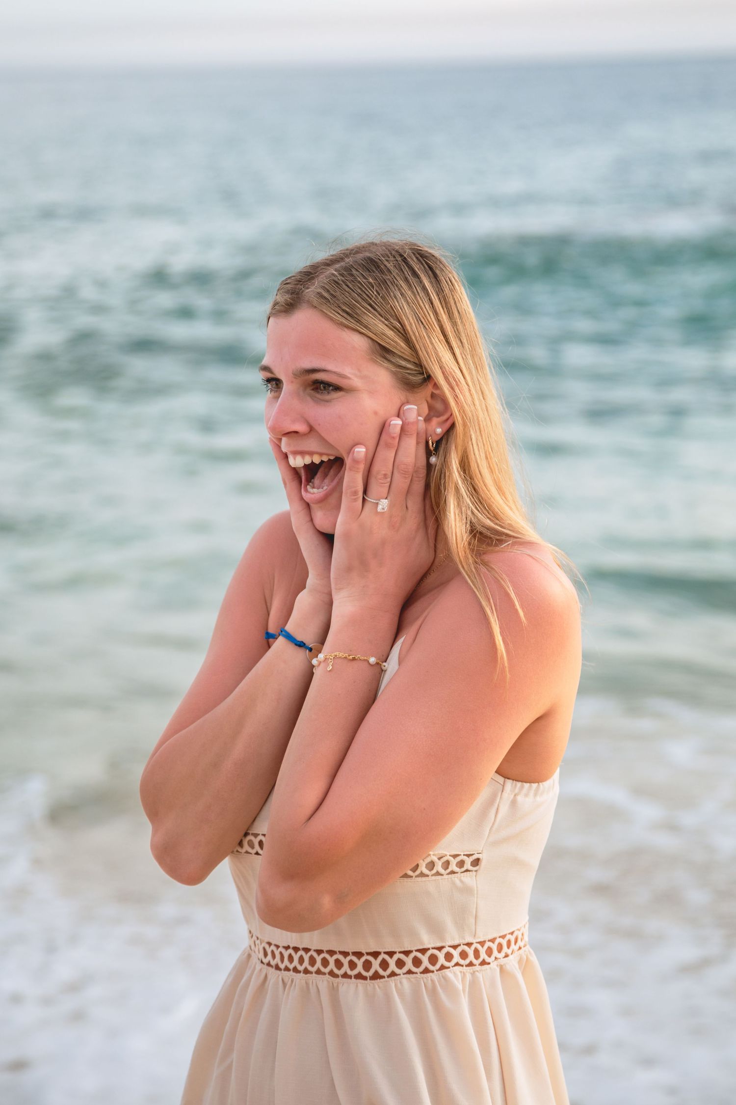 A series of emotional reactions showing surprise and joy on the beach with ocean waves in the background.