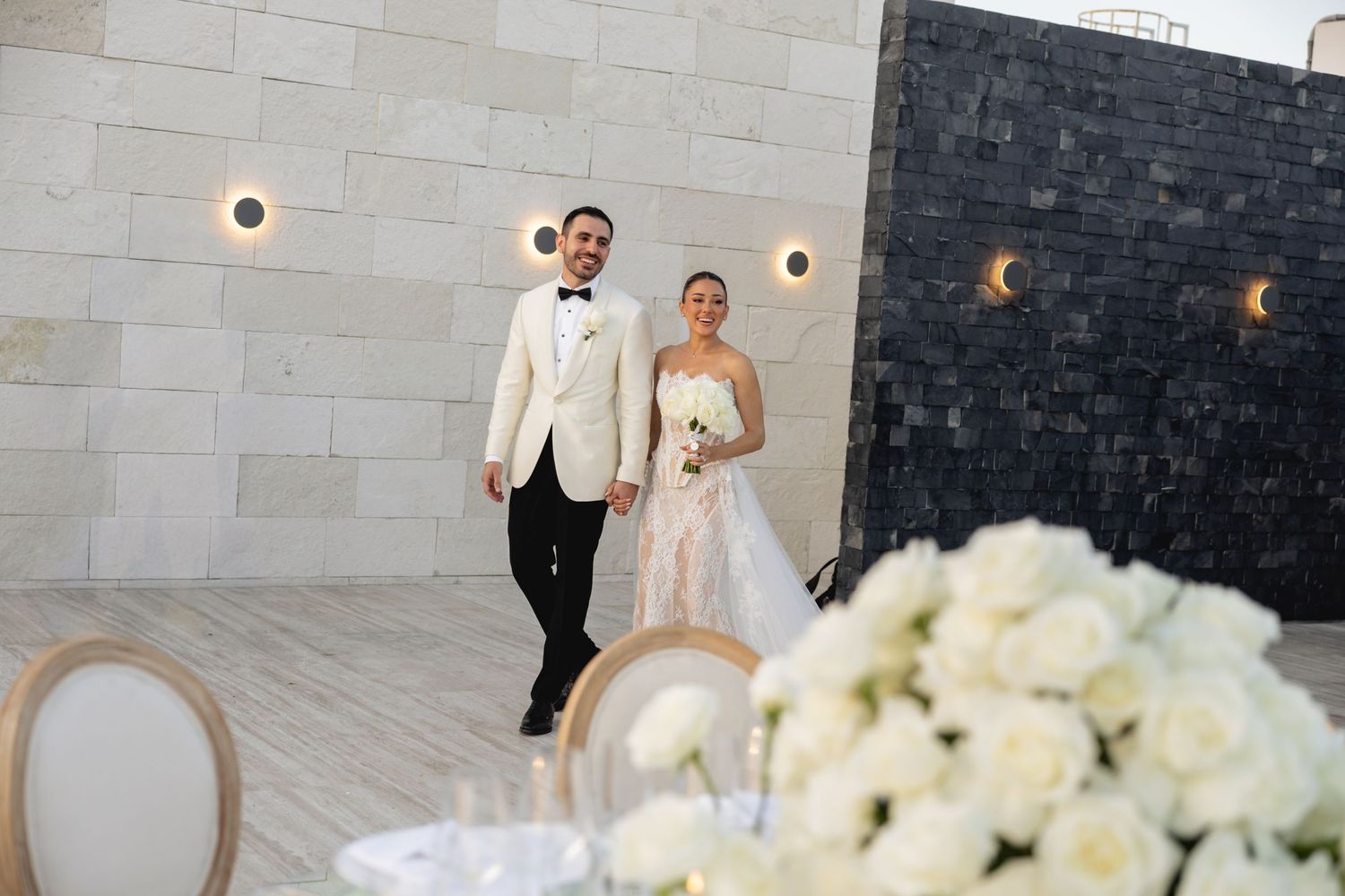 Modern wedding venue with sleek stone walls and elegant decor details.