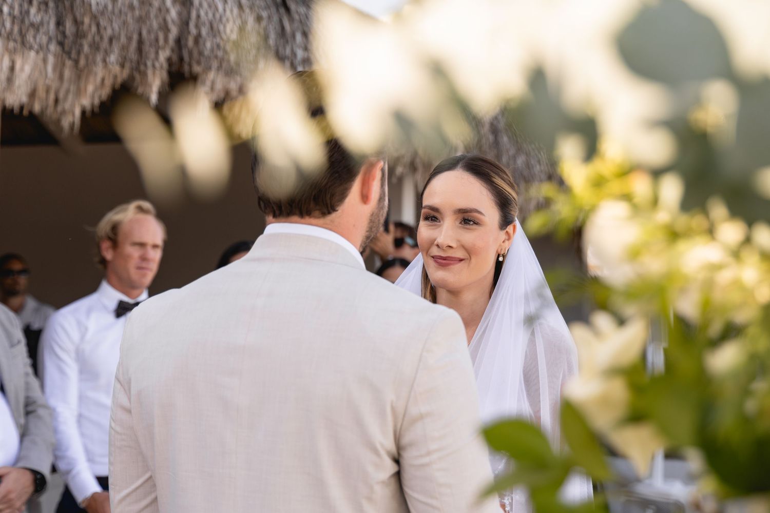 An intimate wedding ceremony moment captured with white floral decorations.