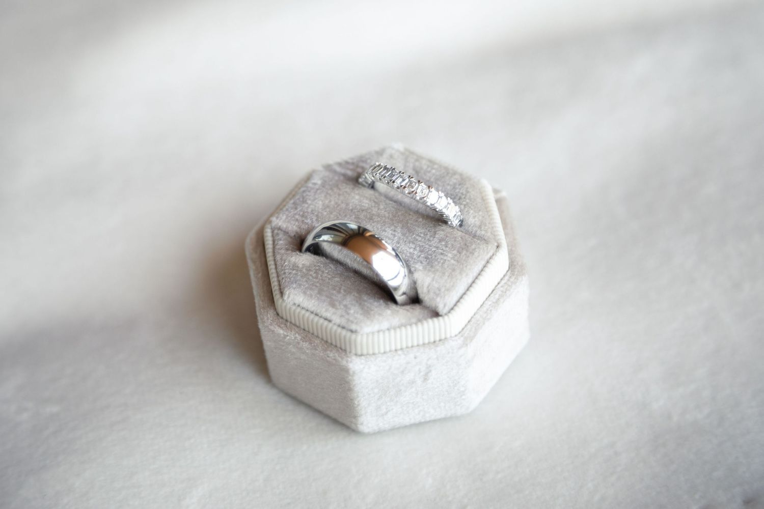 White decorative wedding ring boxes arranged on a light background.