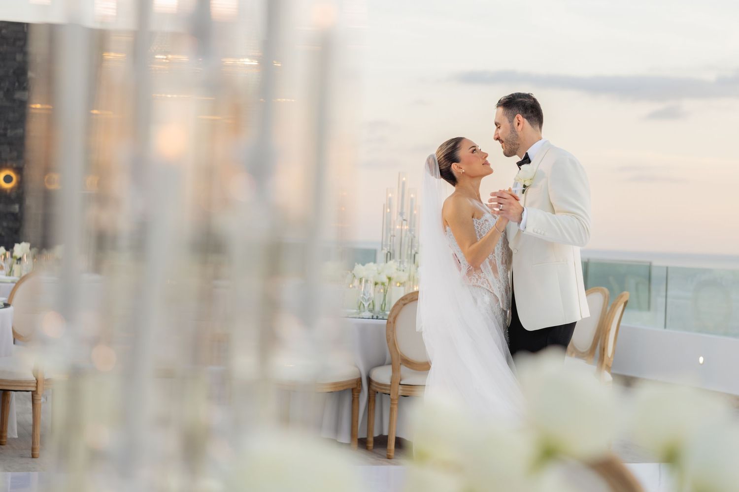 Intimate wedding celebration moment captured through crystal chandelier decorations.