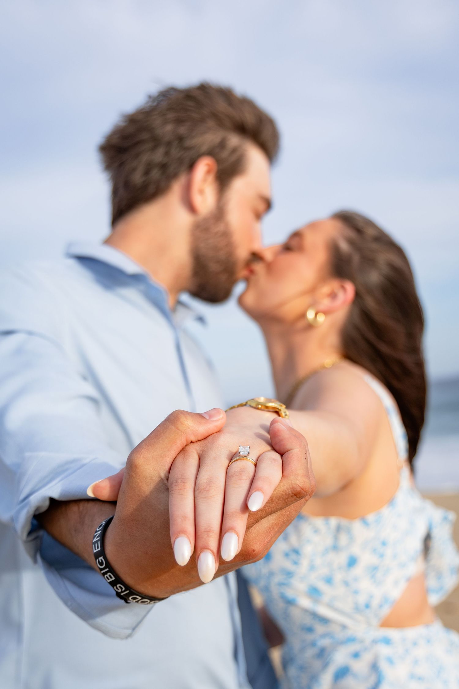 A couple shares a romantic kiss while showing off an engagement ring in a series of close-up photos.