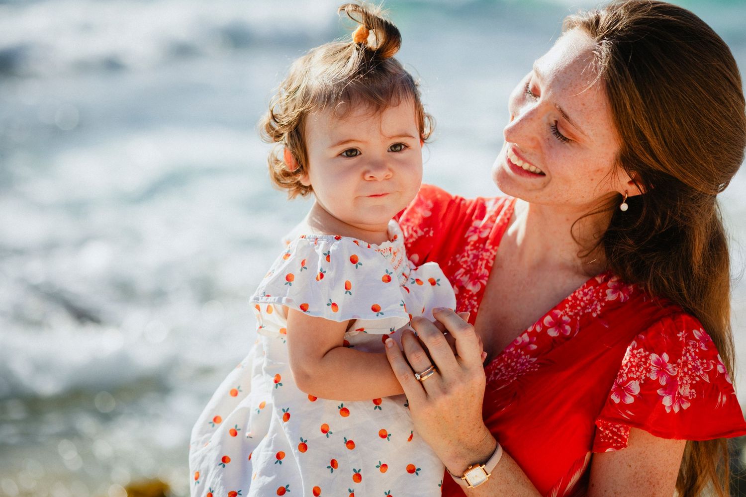 Mother and child sharing tender moments during a beachside photo session.