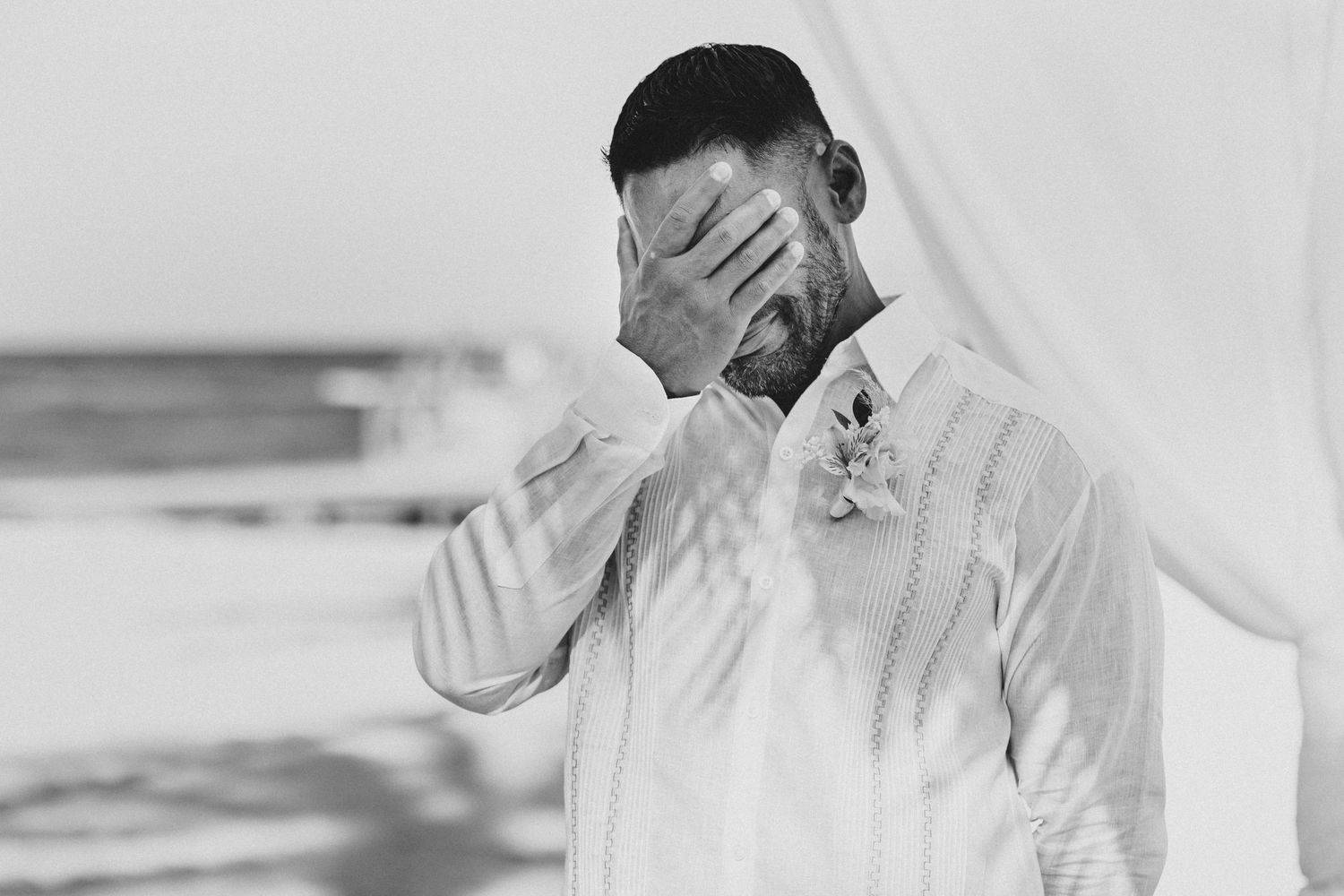 Emotional moment captured in black and white with flowing white fabric.
